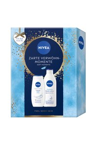 Nivea-Geschenkbox mit Flaschen von Creme Soft Duschgel und Express Körperlotion, beschriftet mit "Sanfte Momente" und "Feel Good Skin", in blau-goldenem Design.