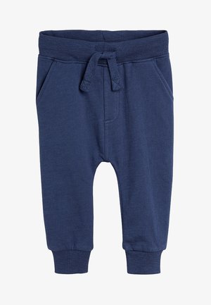 Tumedate sinised spordipüksid, mis on valmistatud pehmest kangast. Omadusteks on nööridega vöökoht, kaks külgtaskut ja elastsed mansetid mugavaks istumiseks.
