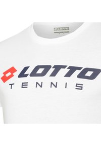 White cotton t-shirt featuring a large navy blue "LOTTO" logo and red accent on the front, suitable for tennis wear. Short-sleeved design.