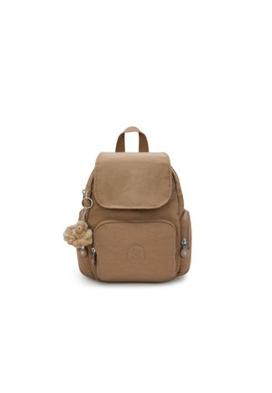 Brown nylon backpack with a flap closure, front zipper pocket, side pockets, and a keychain monkey charm. Features a top handle and logo detail.