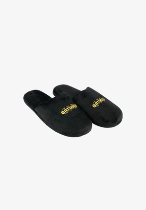 Pantofole in velluto nero con una texture morbida, design con apertura sul retro e ricamo del logo "Batman" dorato sul davanti.