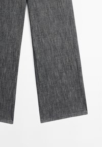 Dark gray wide-leg jeans with vertical texture, featuring a straight cut and clean hem. Made from denim fabric. No visible hardware details.