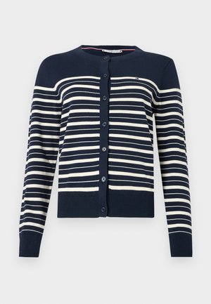 Navy blue cardigan with horizontal cream stripes, featuring a round neckline, front buttons, and ribbed cuffs and hem. Soft knit material.