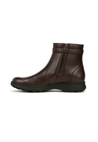 Bottines en cuir marron avec une fermeture éclair sur le côté, semelle en caoutchouc et deux sangles décoratives autour de la cheville pour un détail supplémentaire.