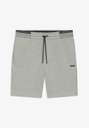 Pantaloni sportivi grigio chiaro con vita regolabile, dettagli neri, tasche laterali e un piccolo logo nero sulla gamba sinistra.