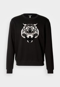 Schwarzer Sweatshirt mit langen Ärmeln, der auf der Vorderseite ein großes weißes Tiger-Design zeigt. Hergestellt aus Baumwolle mit einem klassischen Rundhalsausschnitt.