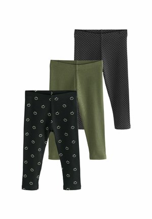 Three pairs of leggings: black with smiley face pattern, olive green with ribbed texture, and dark gray with a checkered pattern.