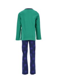 Green long-sleeve shirt paired with navy leggings featuring purple dinosaur prints, made of soft cotton fabric. Simple, comfortable design.