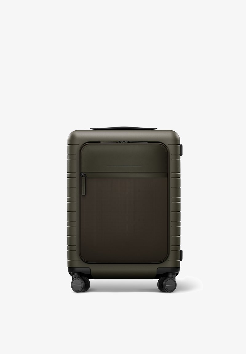 Valise rigide de couleur vert foncé avec une poche avant texturée marron, dotée d'une poignée télescopique et de quatre roues pivotantes.