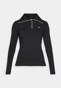 Black long-sleeve polo shirt with a ribbed texture, three-button placket, and contrasting white collar detail. Logo embroidered on the chest.
