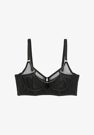 Soutien-gorge en dentelle noire avec armatures et bretelles ajustables, orné d'une délicate chaîne dorée drapée sur le devant.