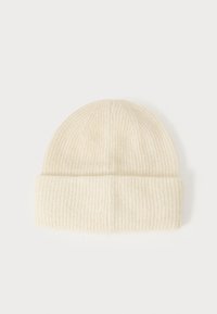Beanie in lana di colore crema chiaro, con una texture a coste, orlo piegato e cima rotonda. Tessuto liscio con una finitura morbida.
