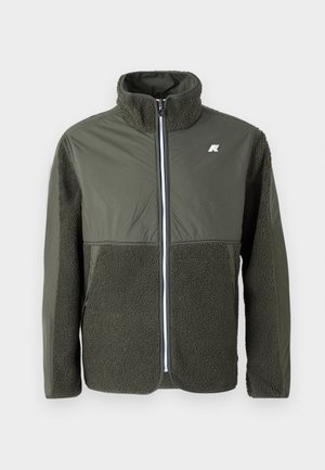 Olive green jacket featuring a furry texture on the lower half and sleeves, smooth upper section, with a full zip and collar.