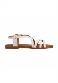 White leather sandals with a flat brown sole, featuring multiple crisscross straps and an adjustable ankle strap for a secure fit.