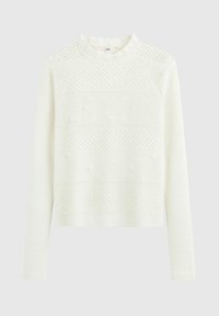Pull long à manches longues blanc avec un col montant, présentant des motifs texturés et de petits éléments décoratifs à l'avant. Matière tricotée douce.