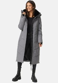 Long gray puffer coat with a hood, quilted design, black faux fur lining, and black accents. Zipper closure and side slits for mobility.