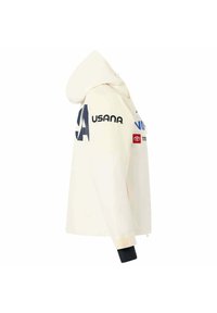 Felpa color crema con zip frontale, un cappuccio ampio e dettagli del logo sulle maniche. I polsini presentano dettagli in nero e velcro.