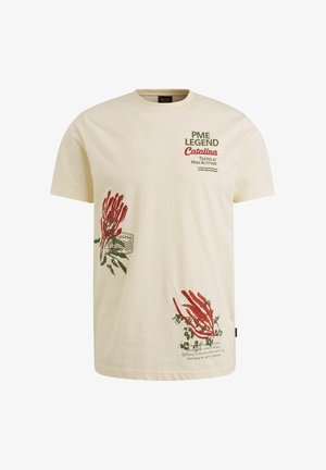 Cremefarvet bomuld t-shirt med røde chili peber grafik og grøn tekst. Har korte ærmer og rund hals.