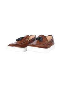 Scarpe slip-on in pelle marrone con accenti neri, suola in gomma bianca e lacci decorativi. Texture liscia con dettagli di cucitura.