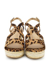Leopard-print sandals with cut-out straps, featuring a chunky espadrille sole and gold accent. Suede texture, open toe design.