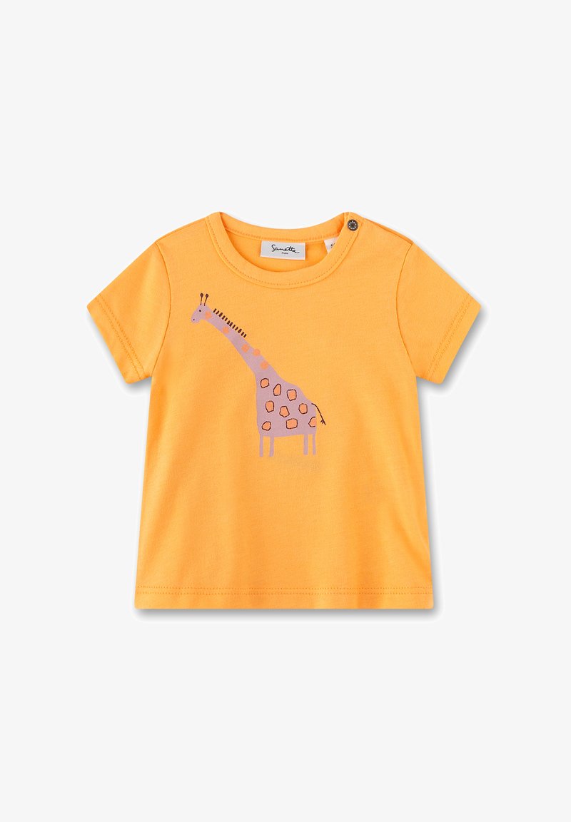 Orange cotton t-shirt featuring a purple giraffe graphic with brown spots, rounded neck, short sleeves, and side snap closure.