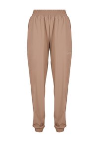 Pantalons de jogging beige avec une taille élastique, des poignets aux chevilles et un tissu léger et lisse avec un discret logo sur le côté.