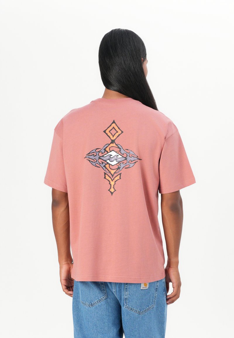 Pink cotton t-shirt with a loose fit, featuring a detailed graphic design in black, orange, and white on the back. Short sleeves, crew neck.