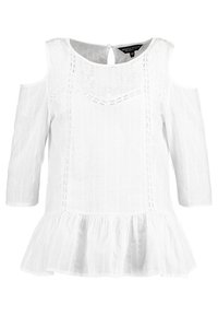 Blusa bianca off-the-shoulder con maniche a tre quarti, dettagli in pizzo, righe verticali e orlo arricciato. Tessuto di cotone leggero.
