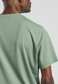 Jack Wolfskin DELGAMI S/S  - T-Shirt sport - eucalyptus