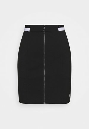 Mini-jupe noire avec fermeture éclair argentée sur le devant et accents de taille blanche, comportant un texte partiel "Calvin Jeans".