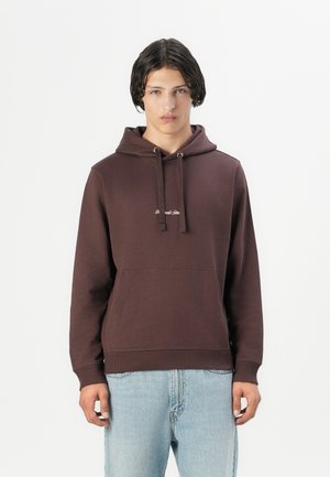 Brown cotton hoodie with a front pocket, adjustable drawstrings, and a small logo on the chest, paired with light blue jeans.