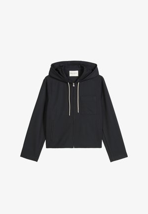Marineblauwe zip-up hoodie van zachte stof met een capuchon met trekkoorden, een voorvak en lange mouwen. Minimalistisch ontwerp met een ontspannen pasvorm.