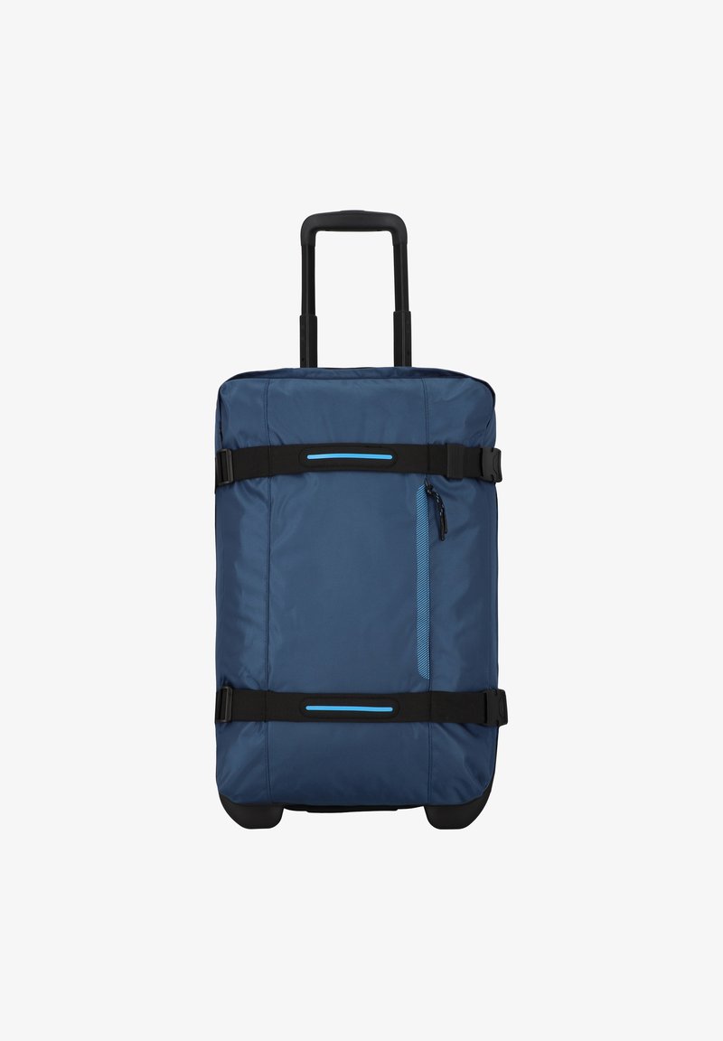 Sac de transport bleu en tissu de forme carrée, avec des poignées noires, une poche zippée à l'avant et une poignée rétractable. Surface texturée avec des accents bleus.