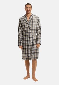 Rutig badrock i beige, blå och svart. Tillverkad av mjukt material, har en sjalkrage, långa ärmar och ett knytbälte. Knälängd design.