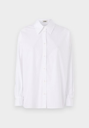 Camicia bianca a maniche lunghe con bottoni, realizzata in cotone, con colletto strutturato, orlo dritto e texture morbida.