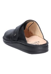 Schwarzer Lederschuh ohne Fersenteil mit gepolsterter beiger Innensohle und breitem verstellbarem Riemen über dem Spann.