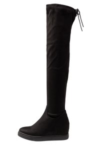 Bottes noires montantes au-dessus du genou en daim souple, présentant une silhouette élégante, un talon compensé et un lien ajustable en haut.