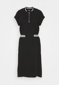 Black dress with short sleeves, a zippered neck, and white striped accents at the waist. Features button details along the side seams.