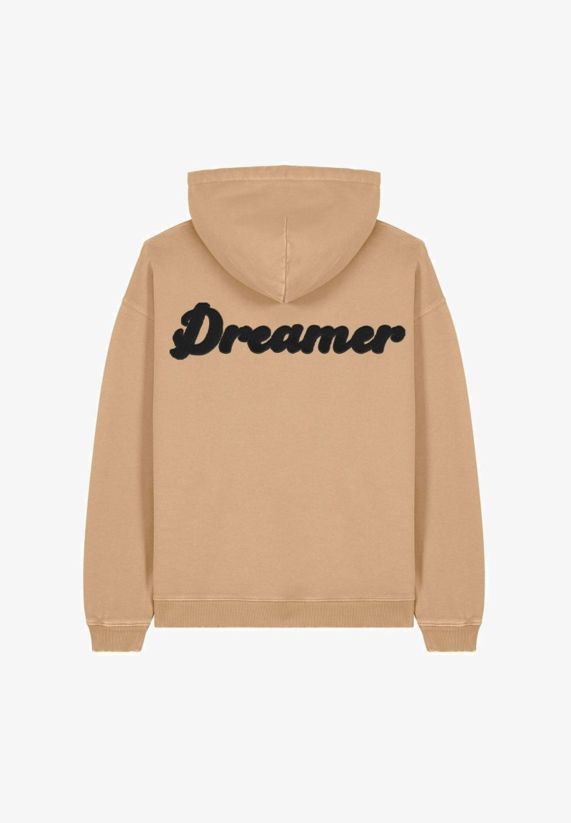 Hoodie beige avec un texte "Dreamer" noir au dos. Comprend une capuche avec cordon de serrage et des poignets et ourlet côtelés. Matière douce en mélange de coton.