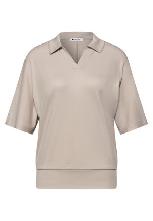 Polo beige à manches courtes avec col en V et coupe ample, doté d’un col et d’un large ourlet en bas.