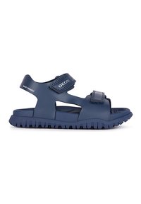 Sandaalit tummansinisestä kumista, avoimella muotoilulla, säädettävillä Velcro-nauhoilla ja kuvioidulla pohjalla pidon lisäämiseksi. Geox-logon näkyvissä.