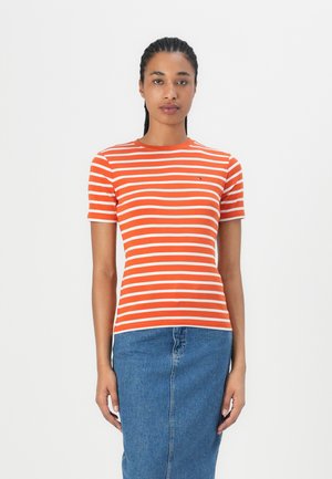 Orange og hvidstribet t-shirt med en rund halsudskæring og korte ærmer, parret med en denimblå nederdel. Fremstillet i bomuldsstof.