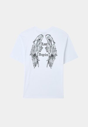 T-shirt in cotone bianco con una grafica di ali e la scritta "Lost Angeles" in nero, dal taglio rilassato e con maniche corte.