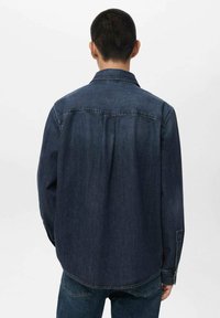 Dark blue denim shirt with a standard collar, long sleeves, and a relaxed fit. Features back yoke and side slits at the hem.