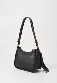 Black leather shoulder bag with a pebbled texture, gold hardware, a zip closure, and a tassel accent on the side.