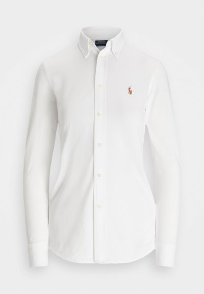 Witte overhemd met lange mouwen en een puntkraag, gemaakt van katoen. Voorzien van een klein geborduurd logo op de linkerborst.