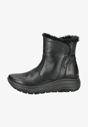 Botín de cuero negro hasta el tobillo con forro de pelo sintético, puntera redondeada, paneles laterales elásticos y suela de goma texturizada. Exterior liso e impermeable.