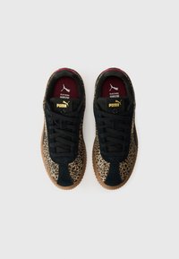 Sneaker con tomaia in suede nero, lati con stampa leopardata e suola in gomma. Presentano lacci neri e il logo Puma dorato sulla linguetta.