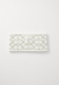 Κεφαλοδέσμος λευκός με υφή και ανάγλυφο, αφηρημένο γκρι μοτίβο. Το υλικό φαίνεται μαλακό και φουντωτό, με απαλό περίγραμμα. Έχει πλάτος περίπου 10 εκ.