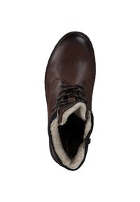 Stivale in pelle marrone alla caviglia con punta rotonda, design con lacci e foderatura in pelliccia lungo il bordo superiore. Caratterizzato da una chiusura con zip sul lato.
